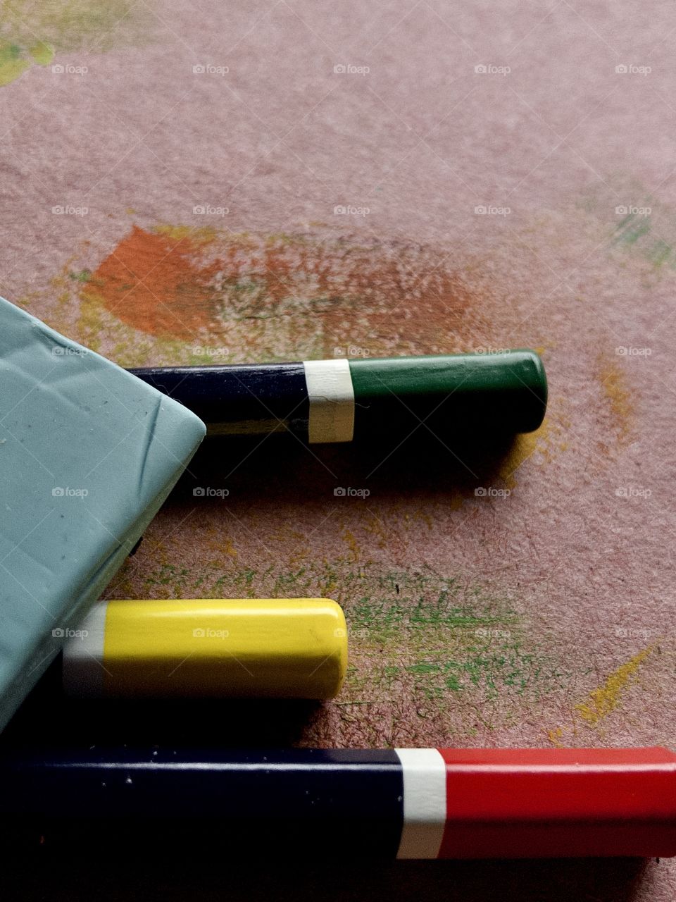 Macro overhead view of colored pencils and blue eraser