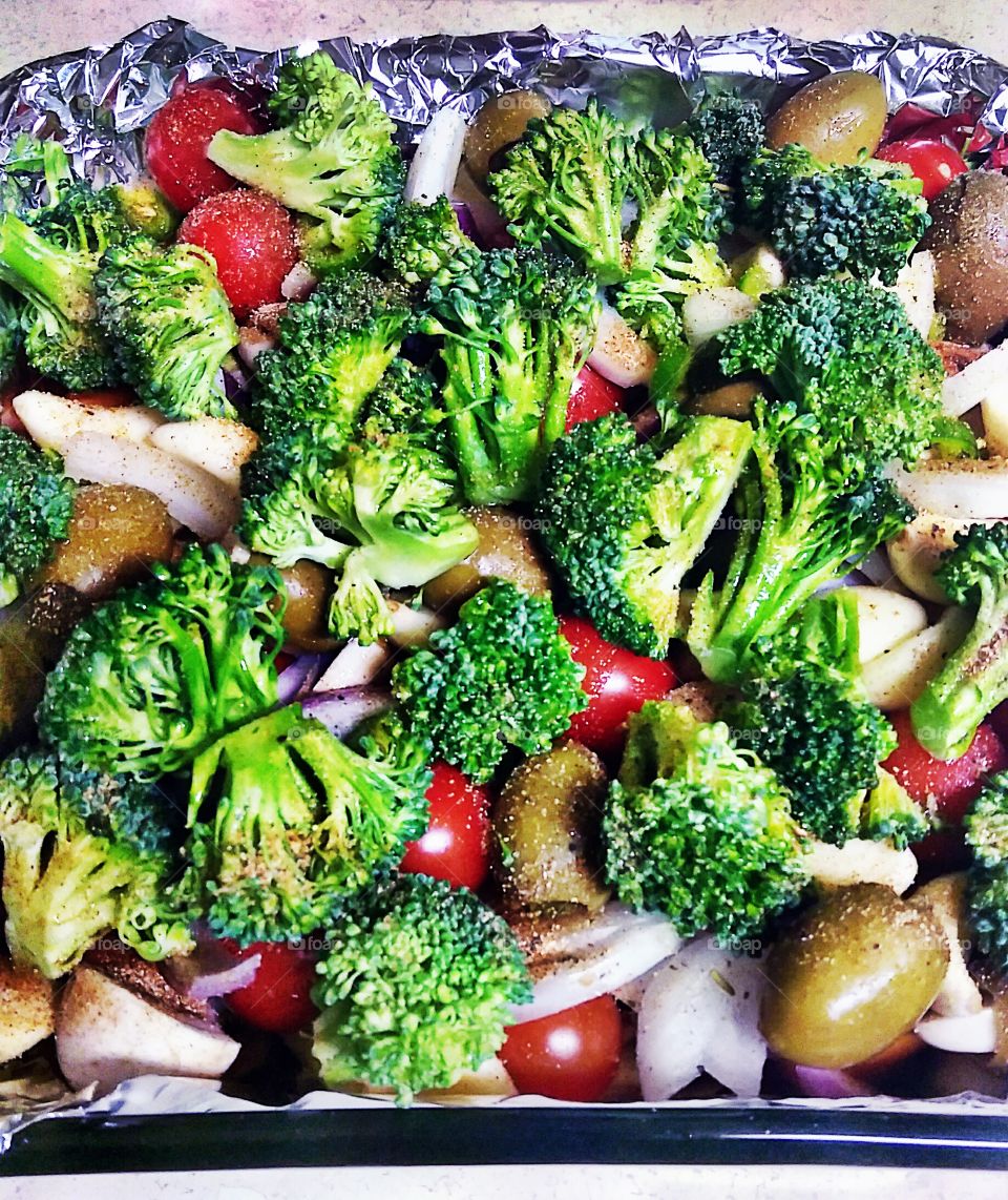 a delicious homemade  heart-healthy meal, broccoli, cherry tomatoes, marinated chicken breast, mushrooms, and white onions