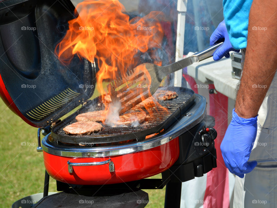 A person preparing barbecue meat