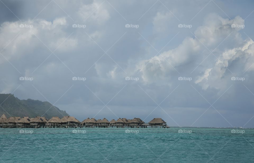 Resort bungalows in the Pacific Ocean of Tahiti.