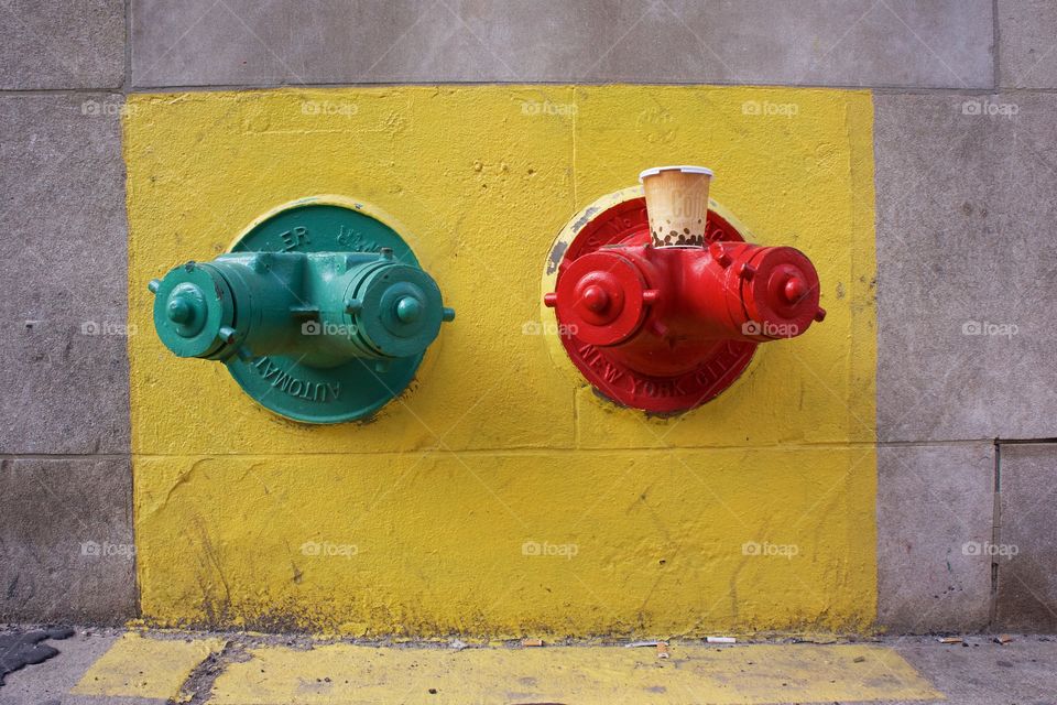 Two Siamese sprinkler couplings on the exterior of a building in Manhattan, New York City which connect and enable fire engines to pump water to the building