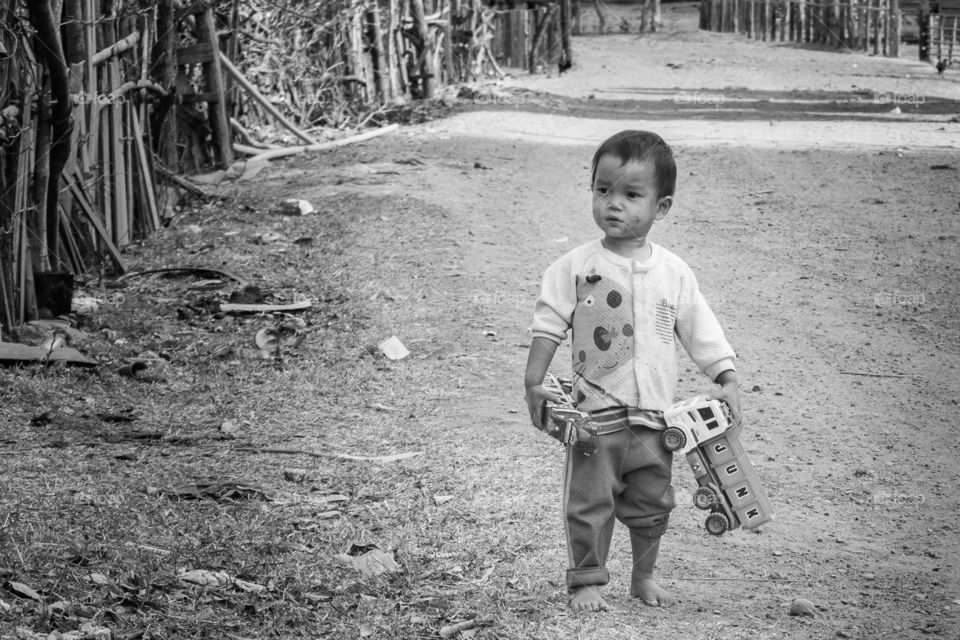 Lonely kid in Lao village