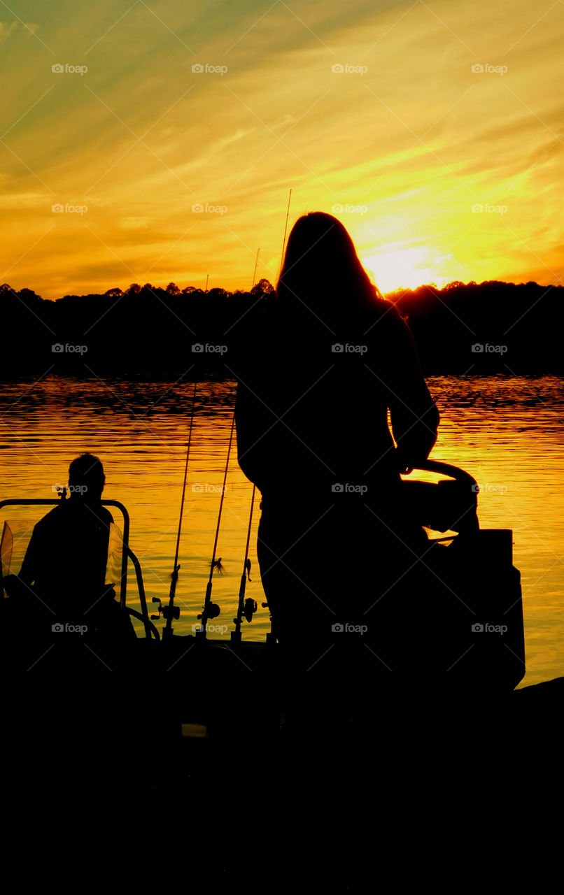 Silhouette of a Woman on the dock of the bay!
The woman is talking to the fisherman!