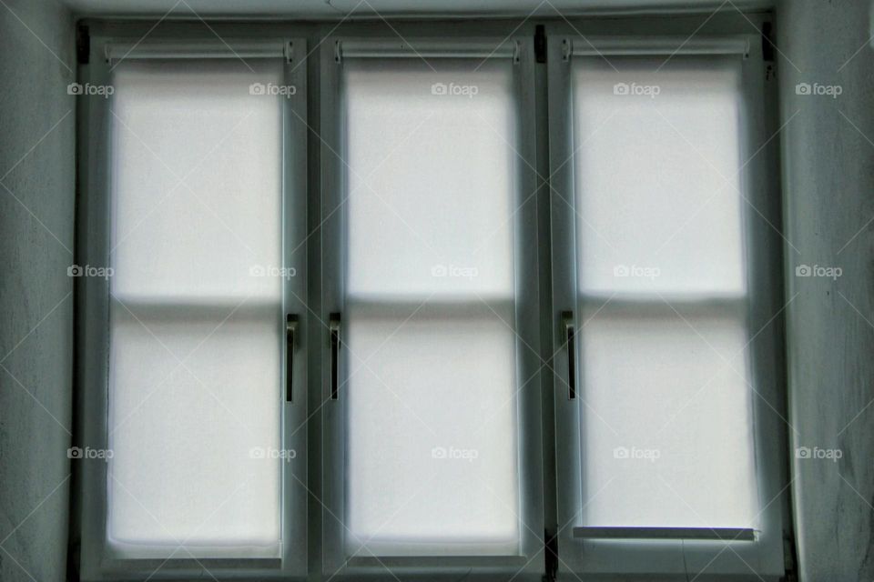 Close up of rectangle windows with white curtain 