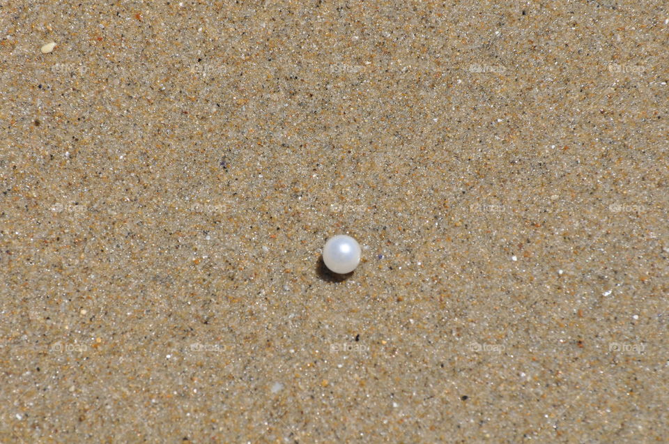 Pearl on the beach sand