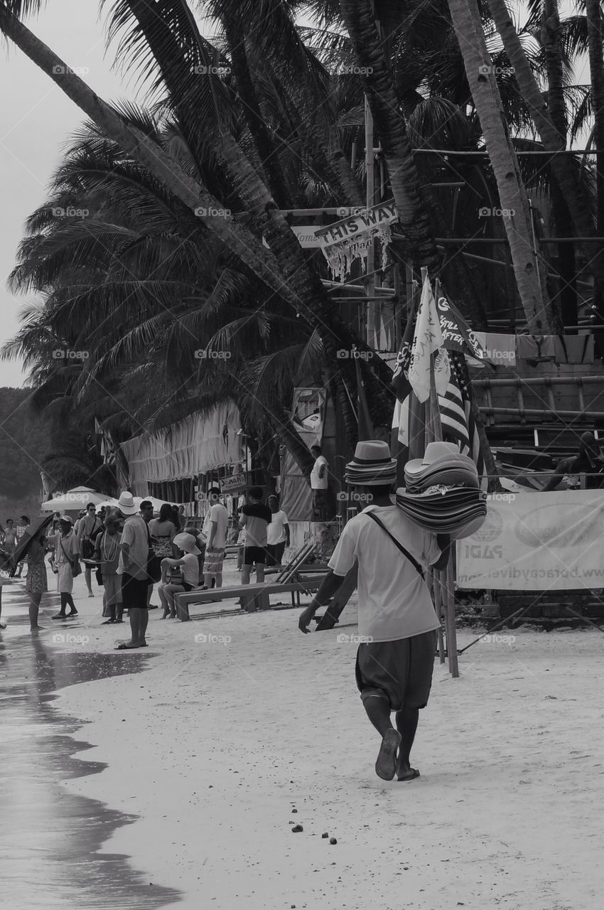 Man selling hats by the beach