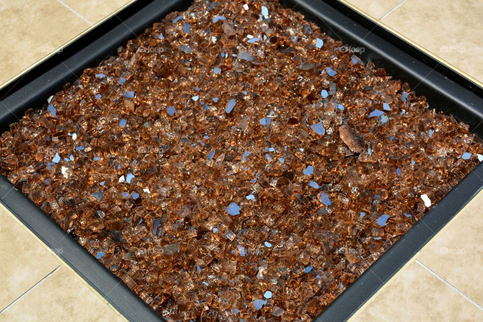 Full frame close-up of golden fire pit glass