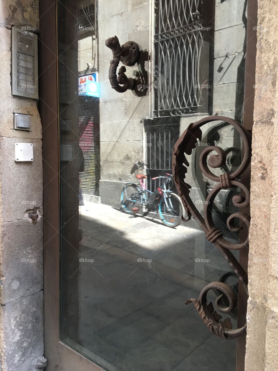 Reflections in the window Barcelona of a bicycle 