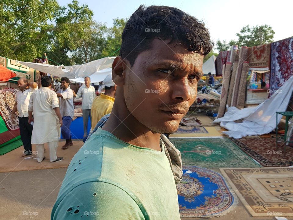 The survivor -This picture was taken at delhi india.He is a worker at old market where many people working hard for their survival.We may look weird to him and we could realise it from the way he look at us while we capture his reaction.His reaction and the pain on his eyes show us we are in a better place and we should appreciate it rather then complaining about our life.