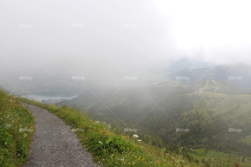 Hiking trail in the mountains at high altitude among the clouds