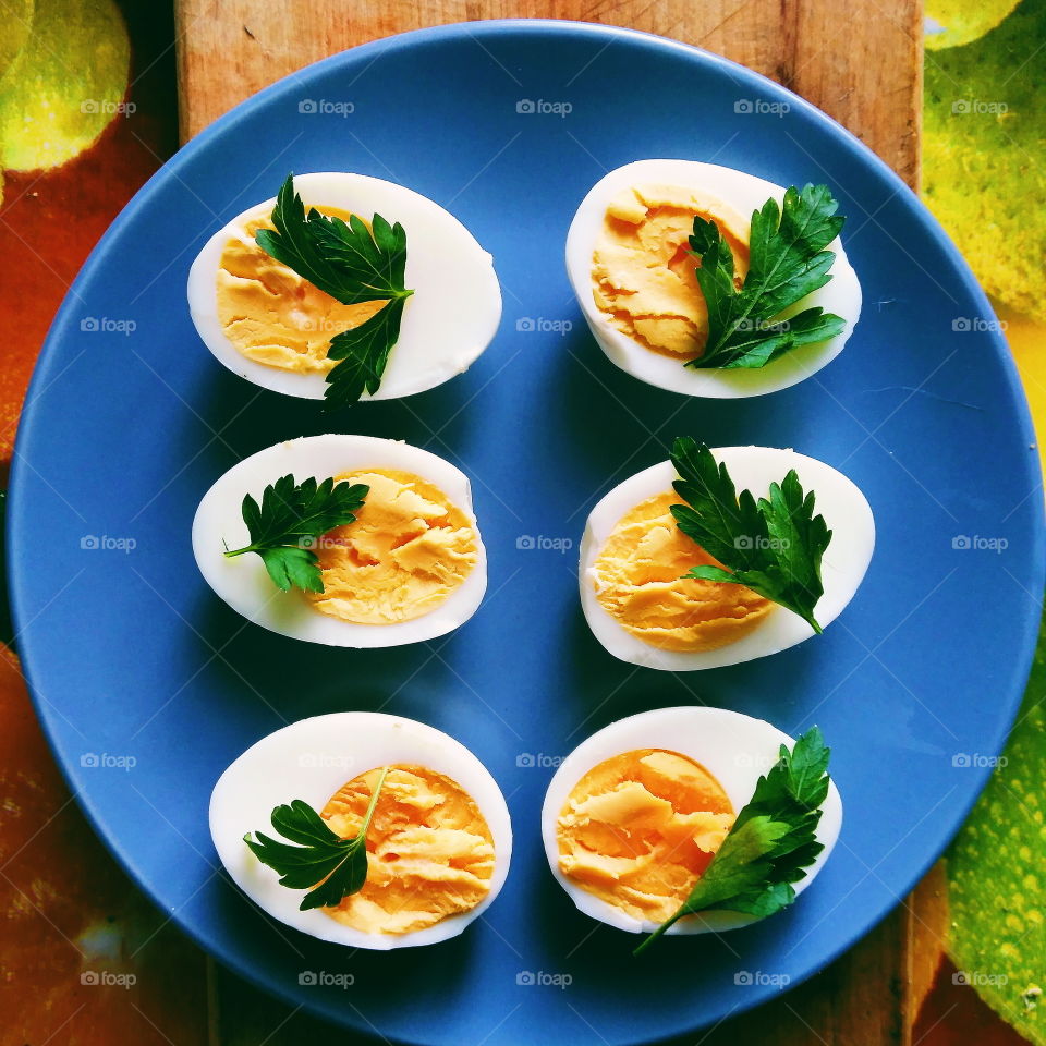 cut boiled eggs decorated with parsley