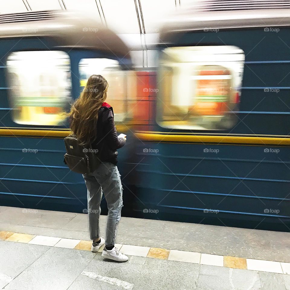 Using mobile phone at subway station 