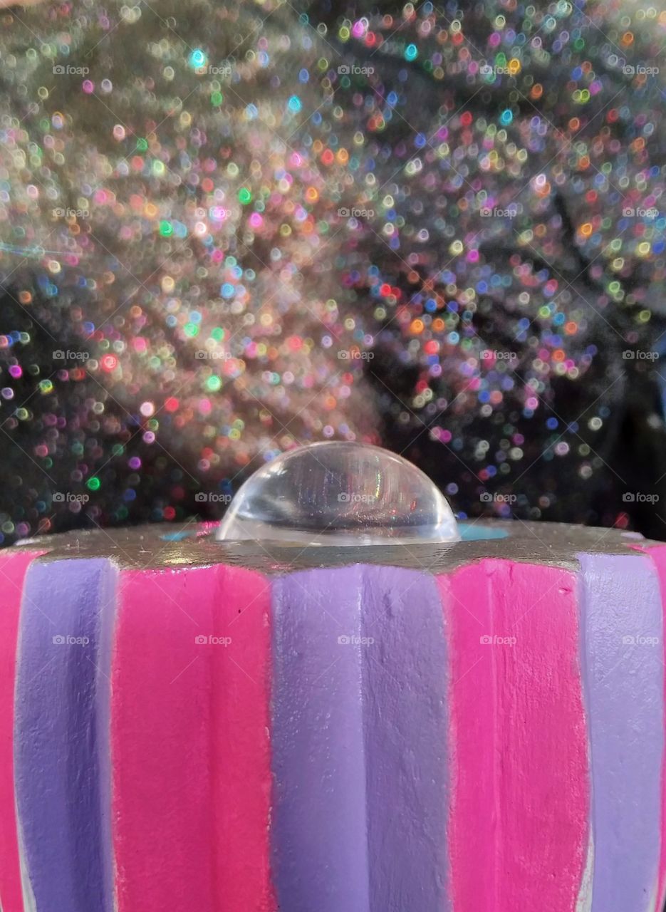 A resin dome reflecting the bokeh background.