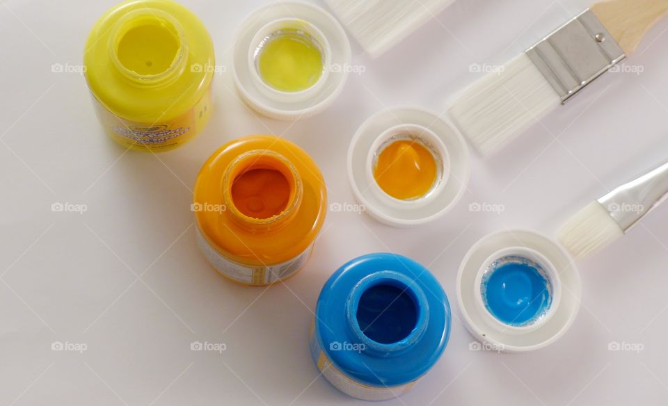 Paint in containers yellow orange blue