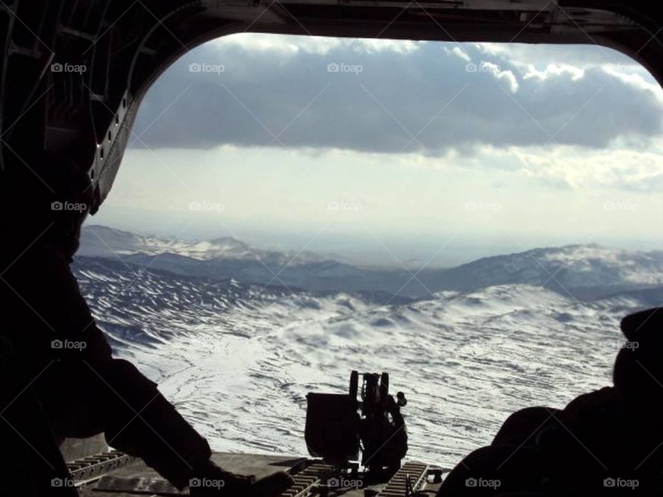Flying over Afghanistan. Looking out the back of a chinook while flying over Afghanistan. Middle of the winter in Ghazni Province. 