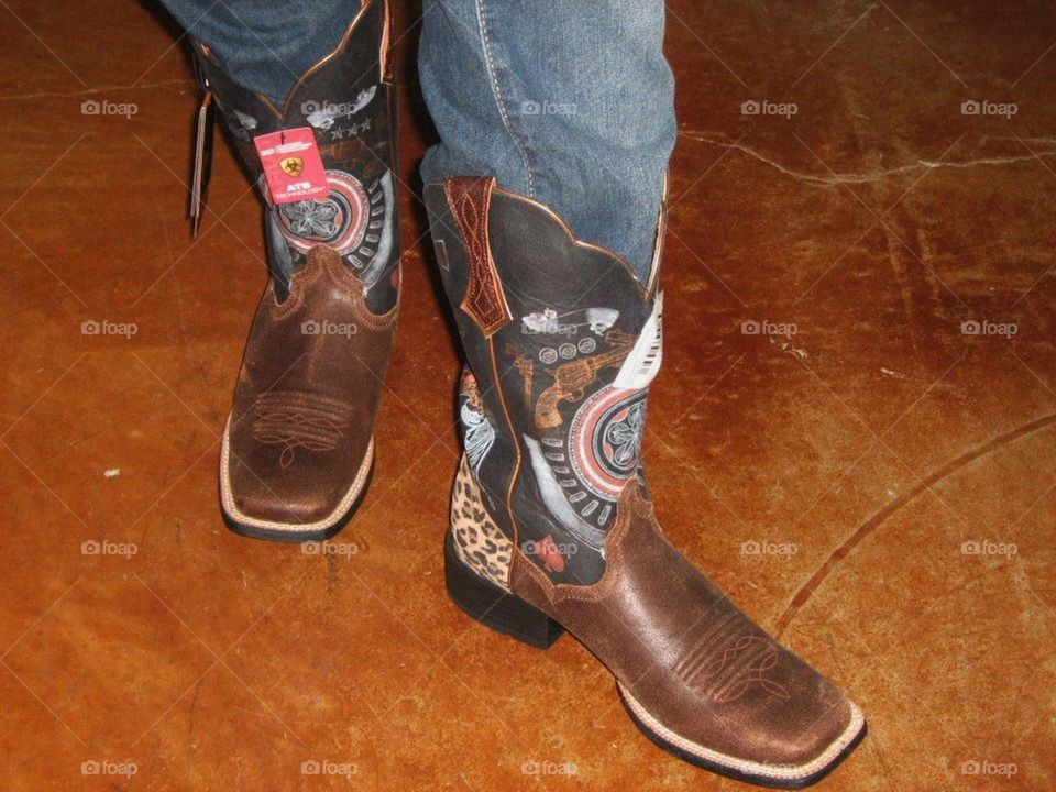 Woman trying on cowgirl boots in Texas 