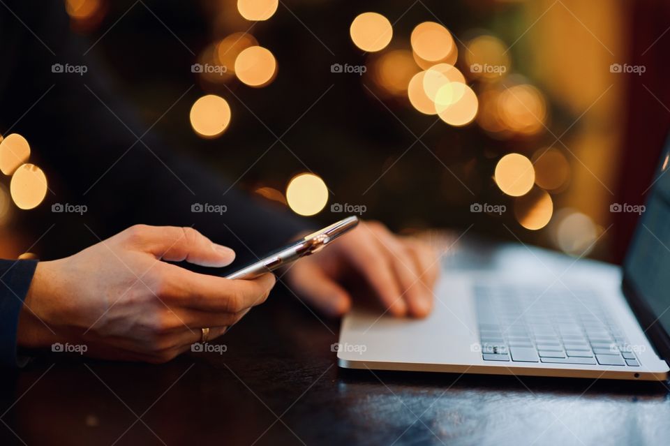 young man dials a message on the phone at christmas