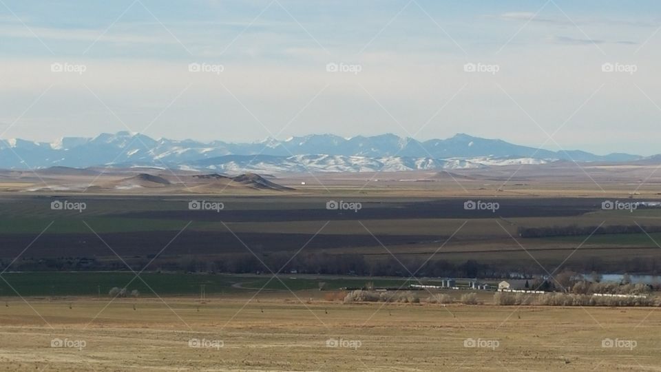 farms and river with a beautiful mountain background