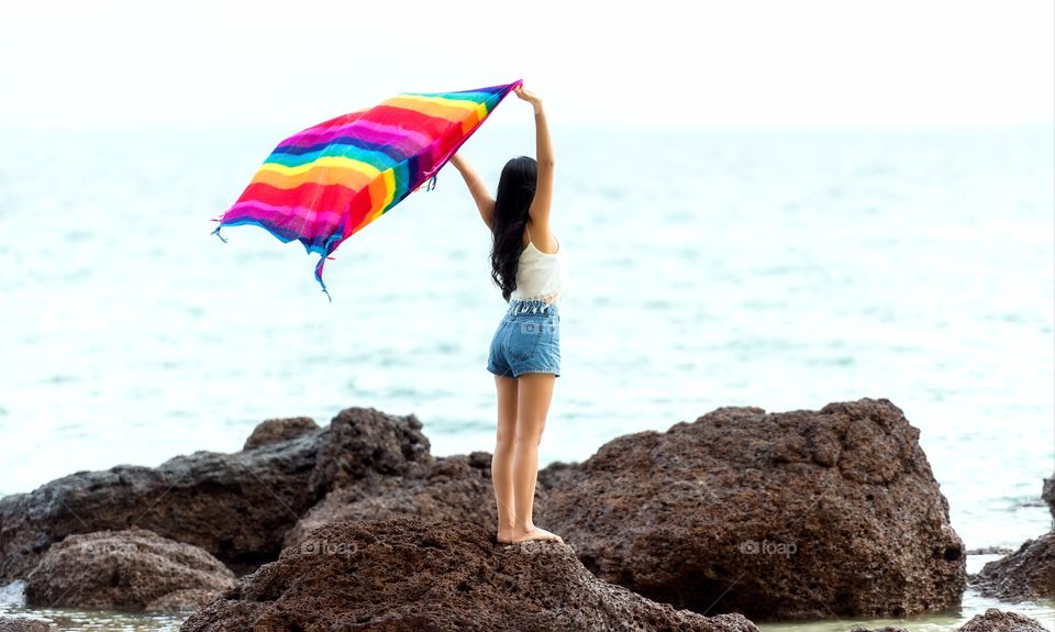 the girl is standing on a stone