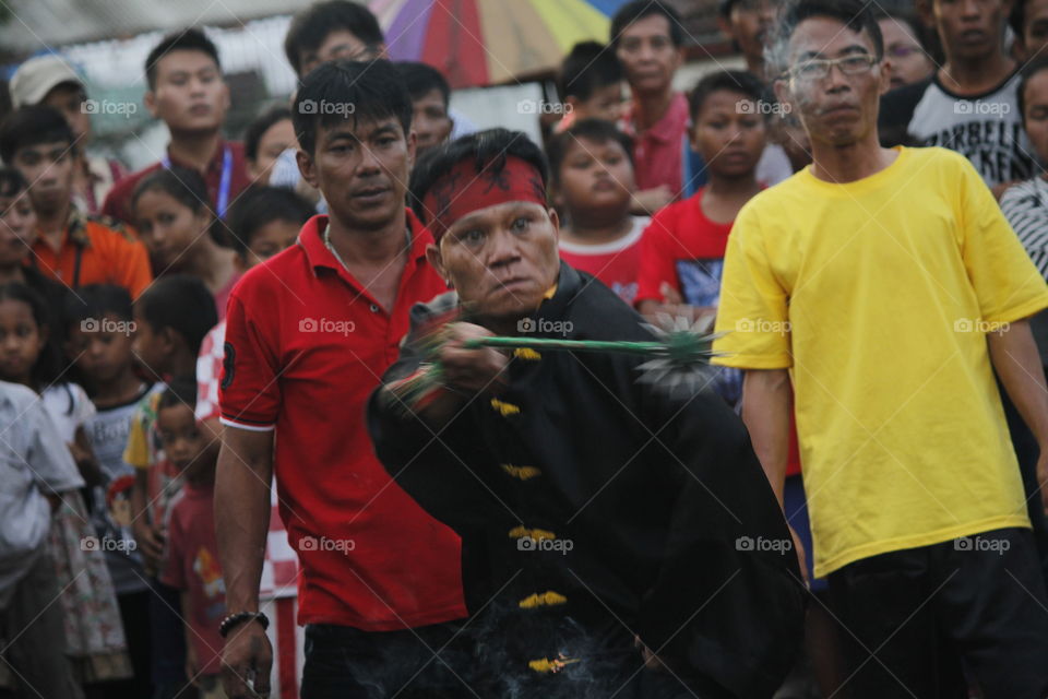 old man was playing a spiked iron ball