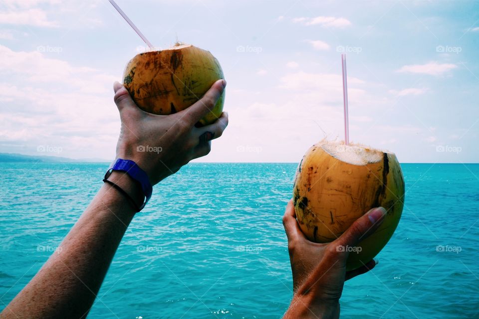 Two hand holding coconut