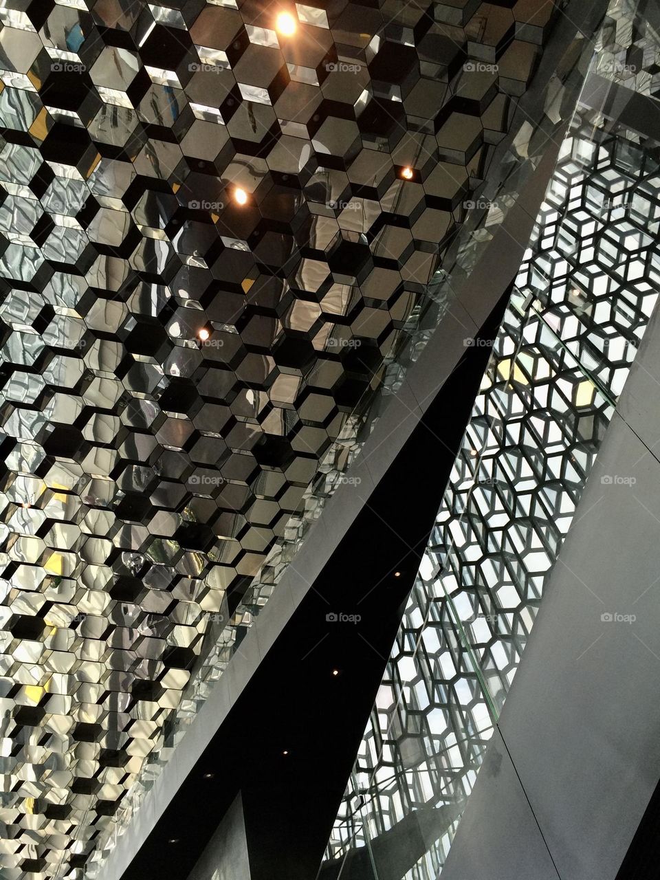 Architectural reflection of light and dark on ceiling and glass walls in landmark building