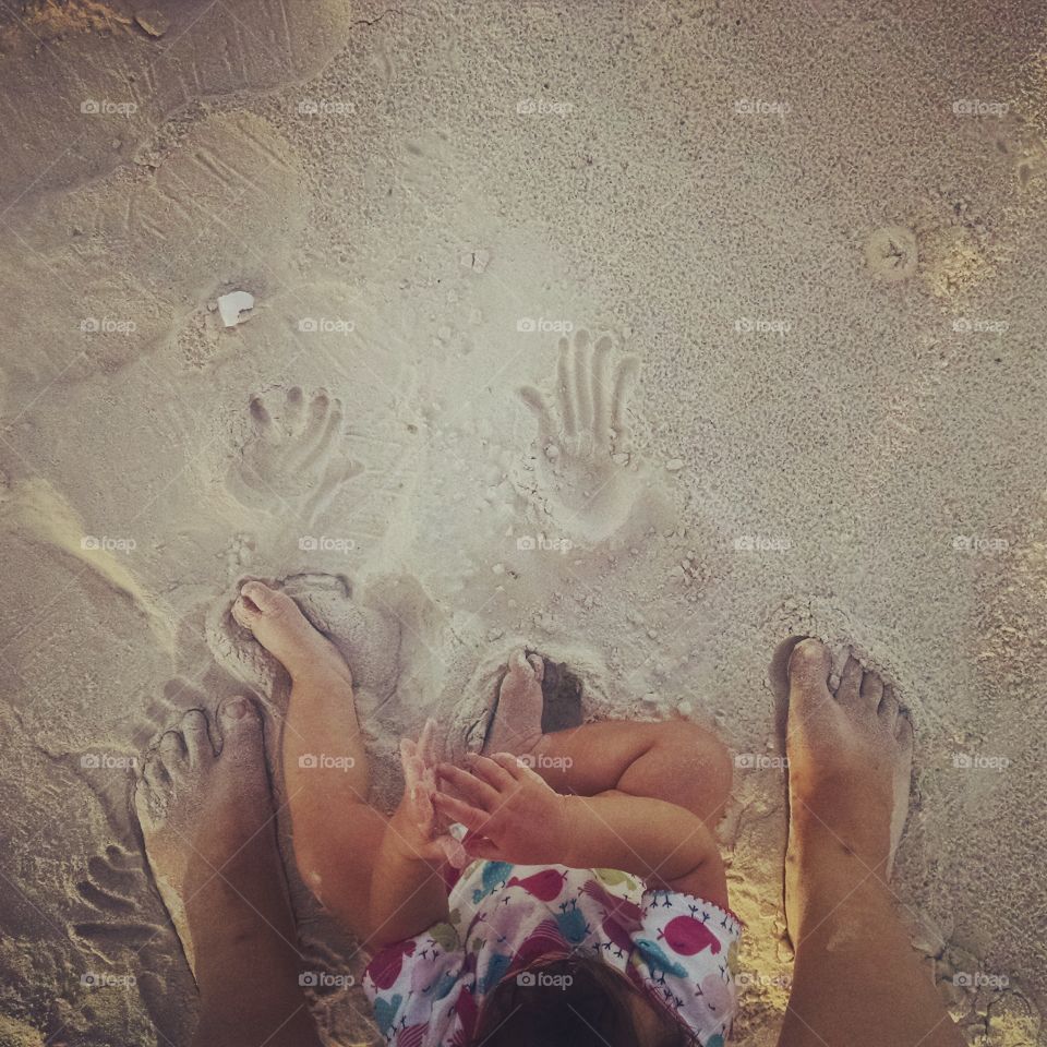 I'm the sand. baby explores sand at the beach