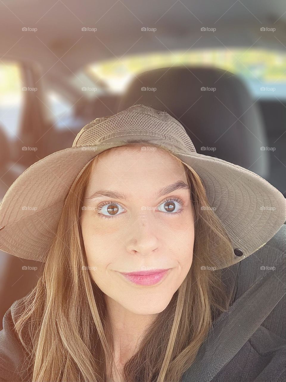 Smiling woman in a hat.