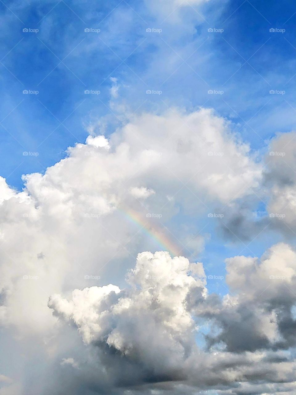 Cloud, rainbow and the blue sky