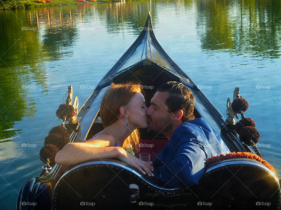 Young couple kissing in canoe on lake