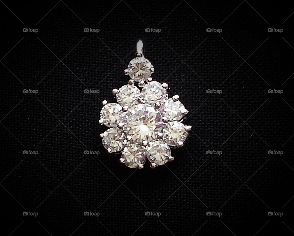 Diamond flower pendant on black background 