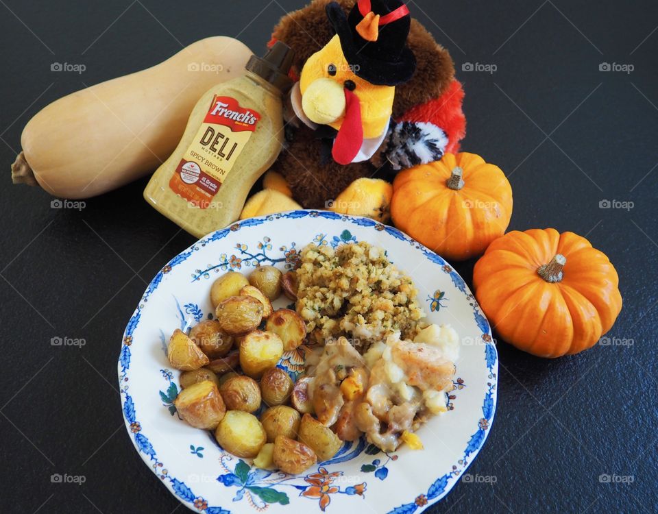 Thanksgiving plate of turkey in a creamy French’s deli mustard sauce with stuffing and roasted potatoes.