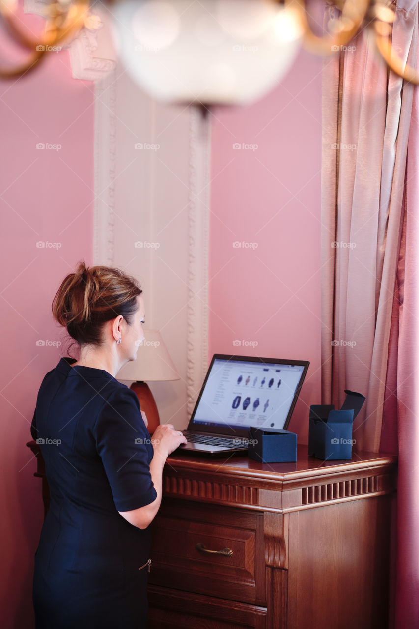 Woman shopping online from home on her laptop computer