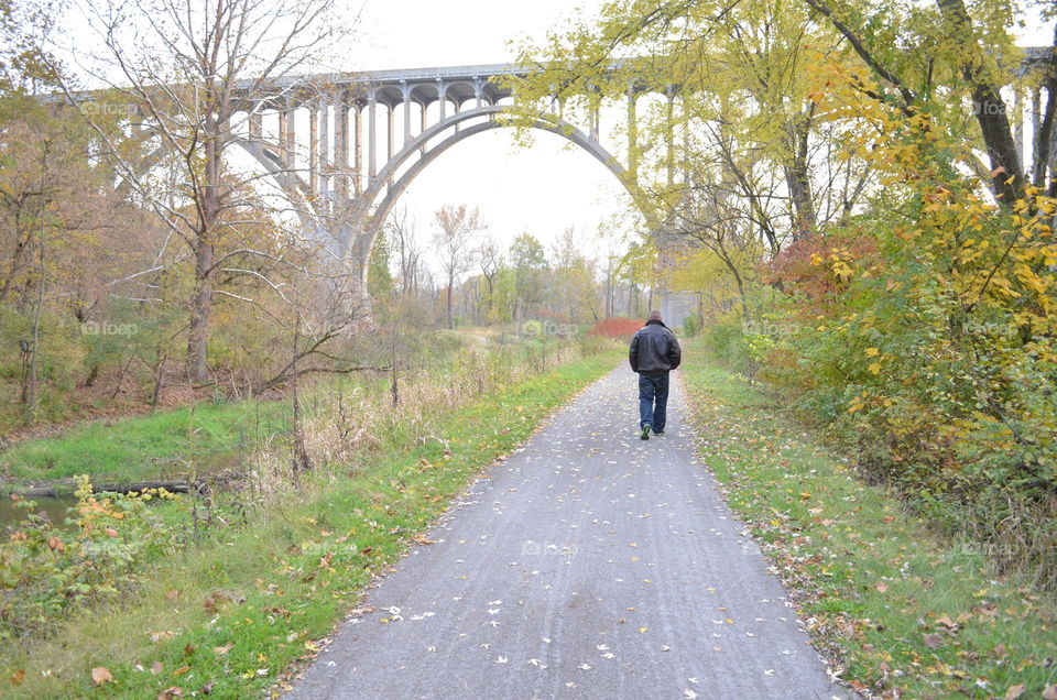 Man on path. Path under bridge with man walking 