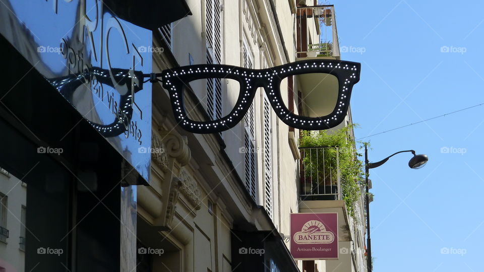 Sign of Sunglasses in Paris ,beautiful sign  with black and silver glasses frame , street photography 