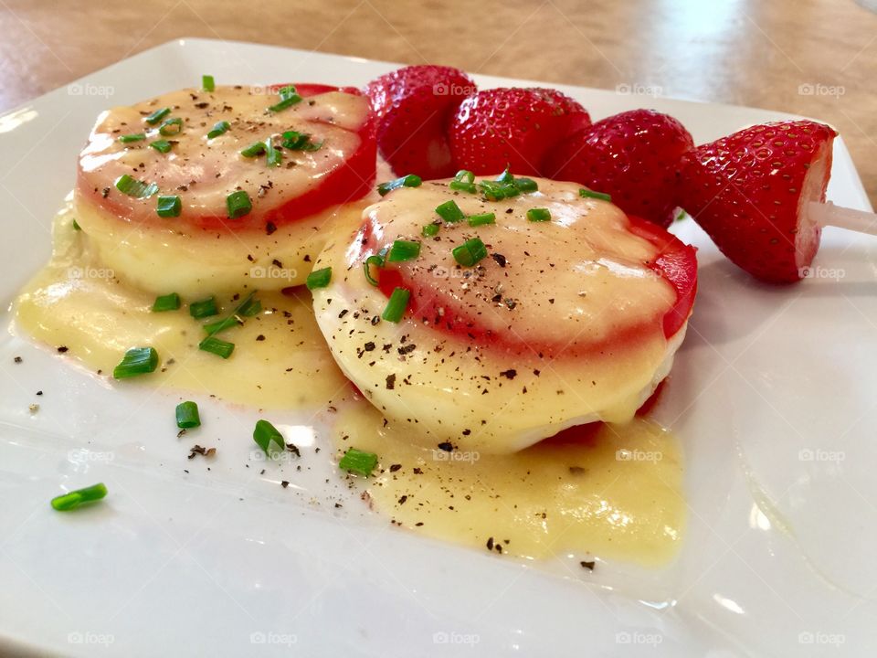 Skinny Eggs Benedict - No biscuits bun just tomato & Eggs with Hollandaise sauce enjoyed with organic strawberries on skewer.