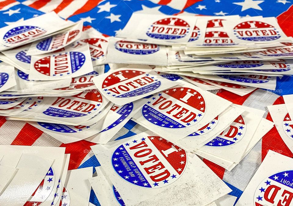 A pile of I Voted stickers at a local voting spot for the midterm elections.  Red, white and blue, proud voter.