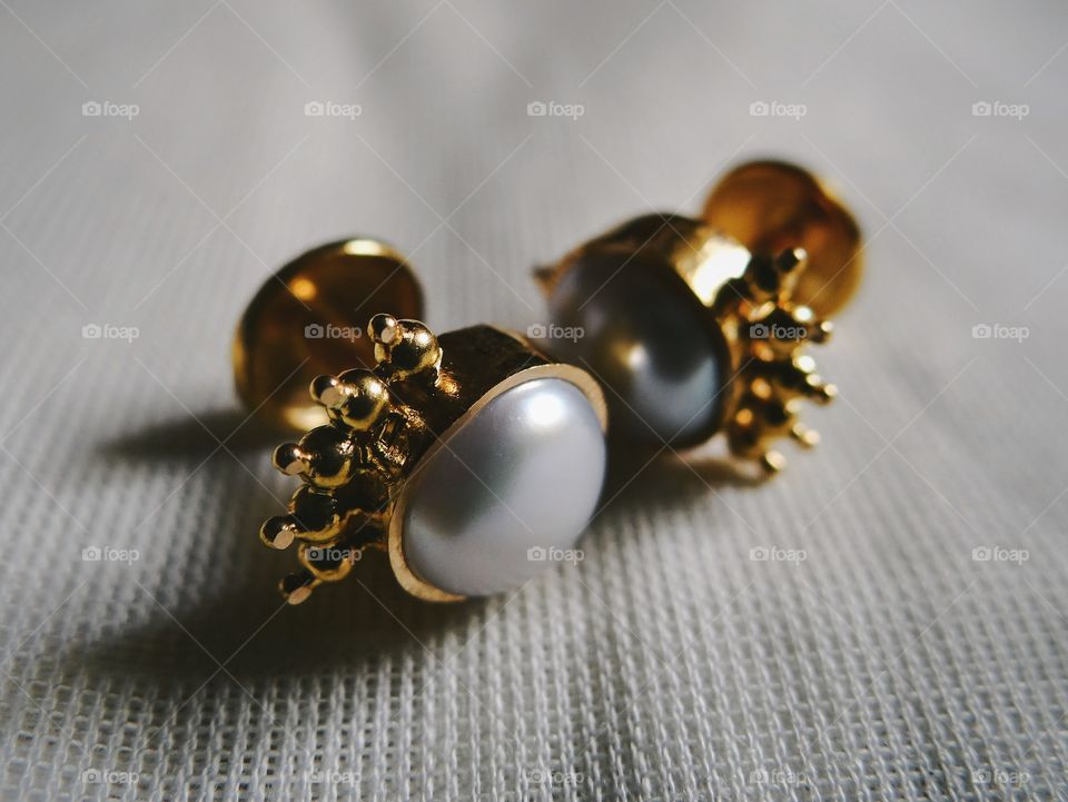 Pearl studded gold ear studs
