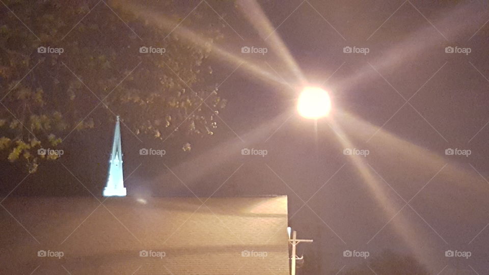 a star and a steeple. Just a cool pic of a steeple behind the building where the light was shining neatly.