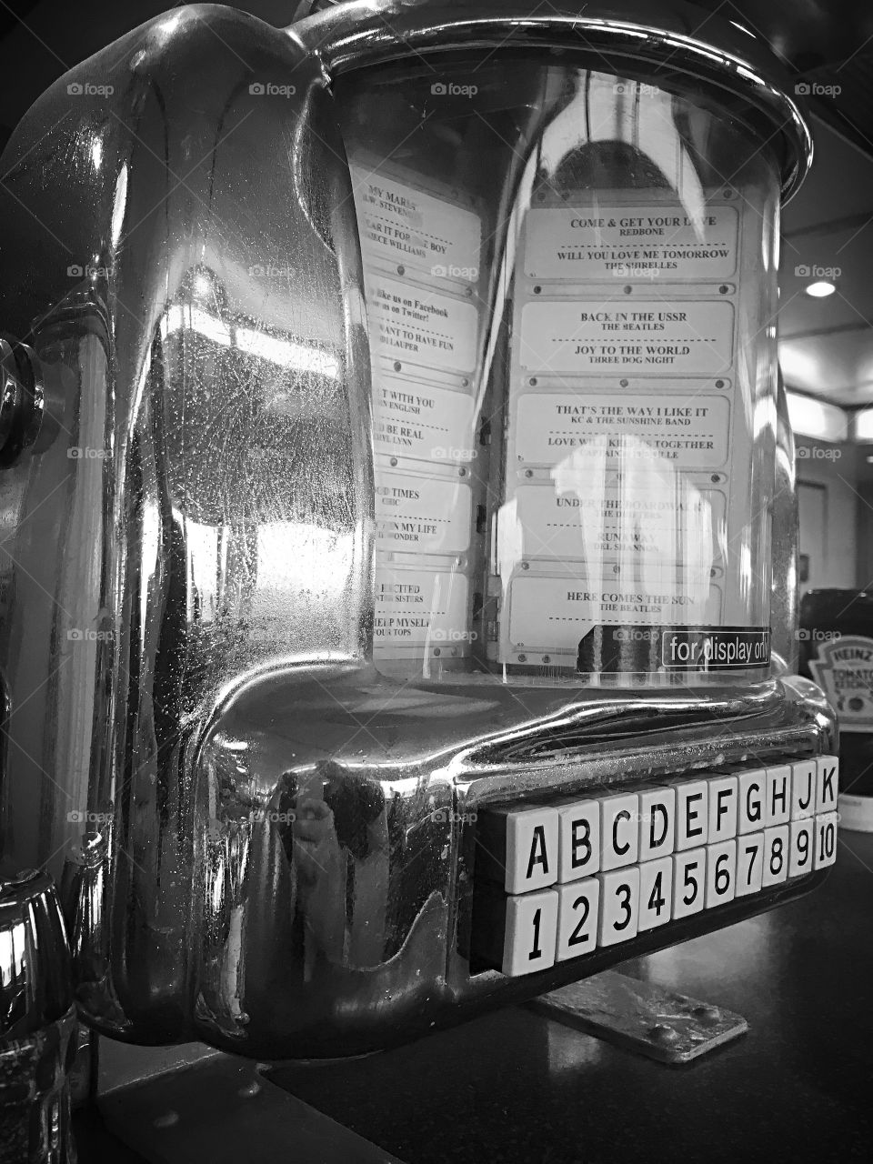 Old fashioned counter juke box in black and white.  Love the classic look, shiny and clean. 