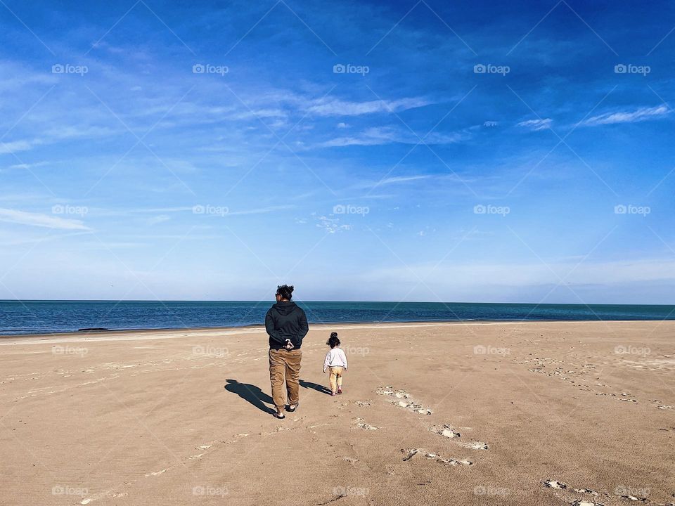 Walking on the beach, mother walking with toddler on the beach, shadows in the sand, walking with shadows on the beach, enjoying the beach in autumn, lonely on the beach in Michigan 