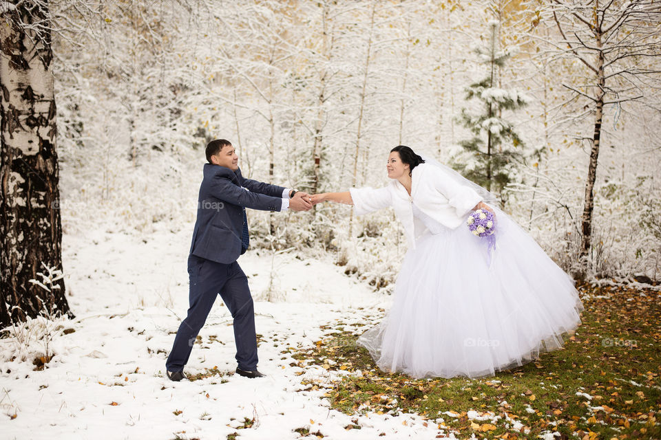 Mid adult married couple standing in forest