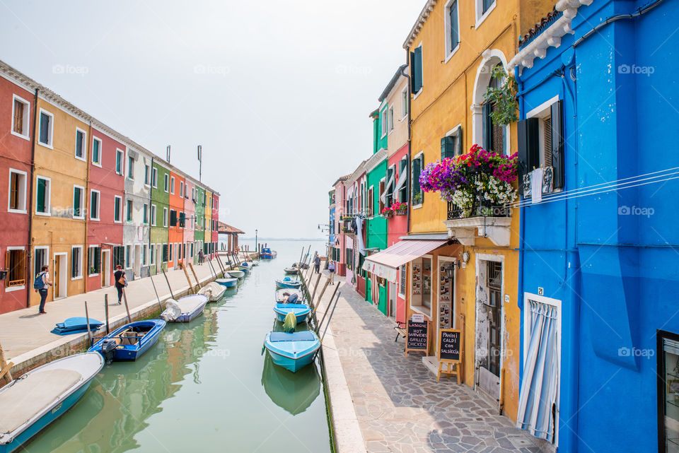 Boats in canal with buildings