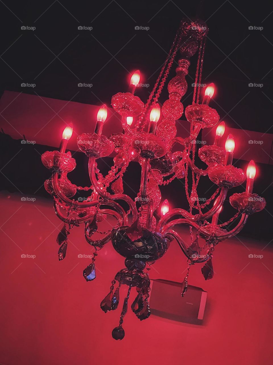 Red chandelier hanging from a restaurant ceiling 