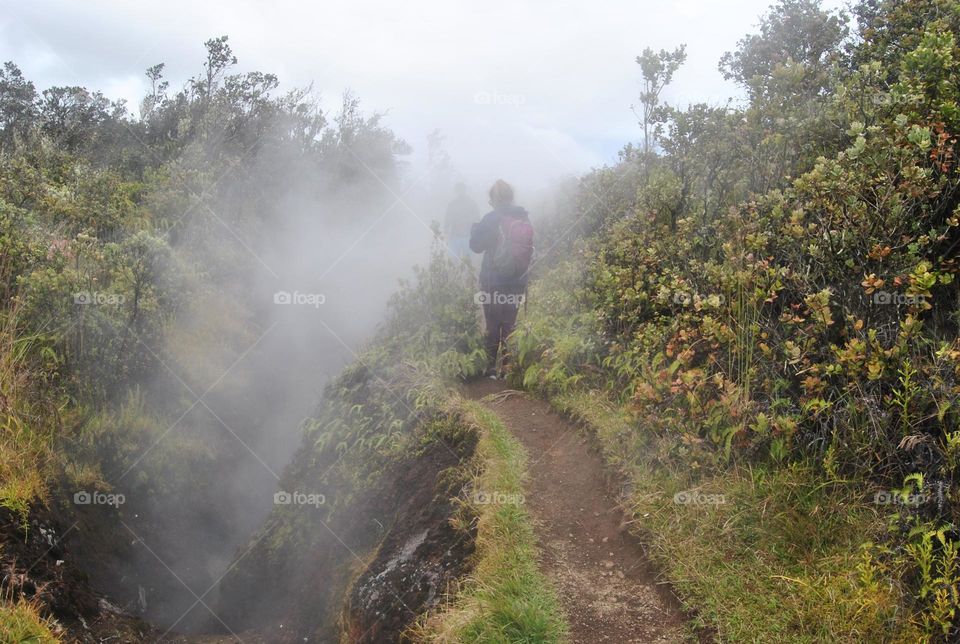 Woman looking for a signal on a steam vents trail