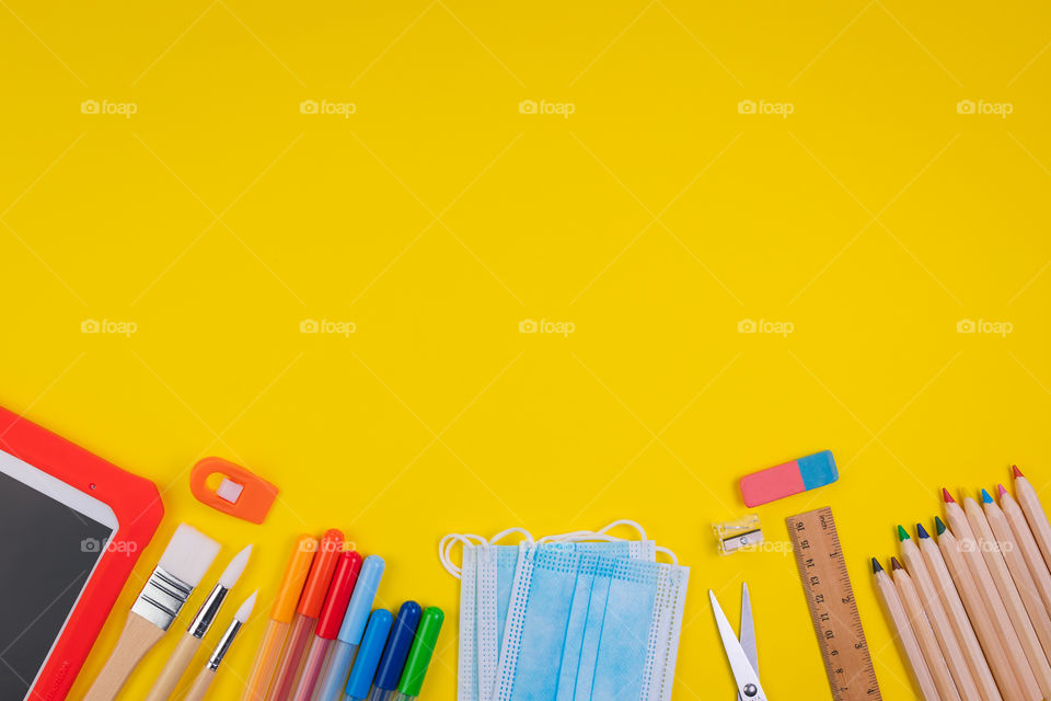 Set of school items on orange background. Back to school concept. Top view. Copy space