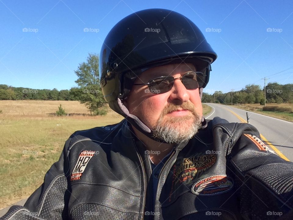 Man riding his Harley Davidson motorcycle 