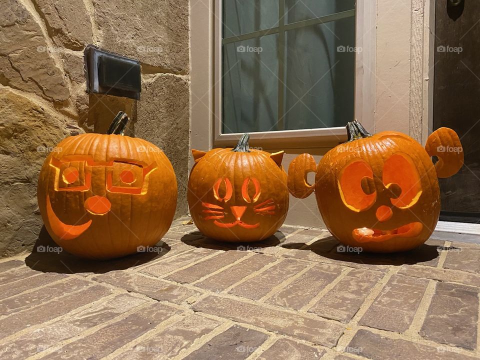 Funny carved pumpkins for halloween, jack-o-lanterns with candles