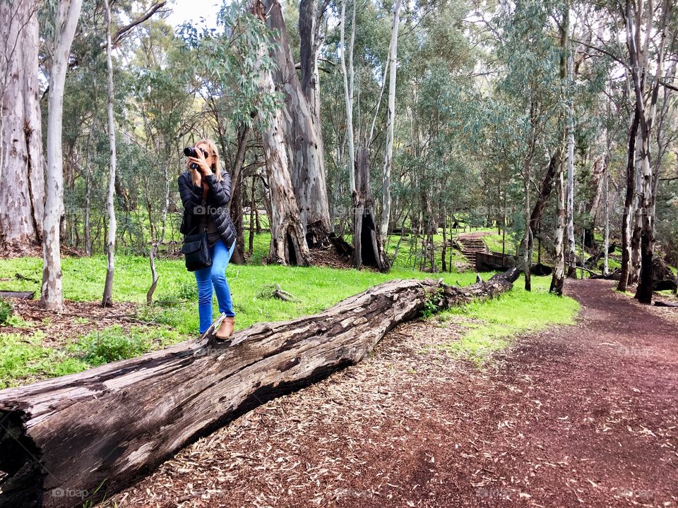 A female FOAP photographer balancing on a log for the shot! Outdoors 