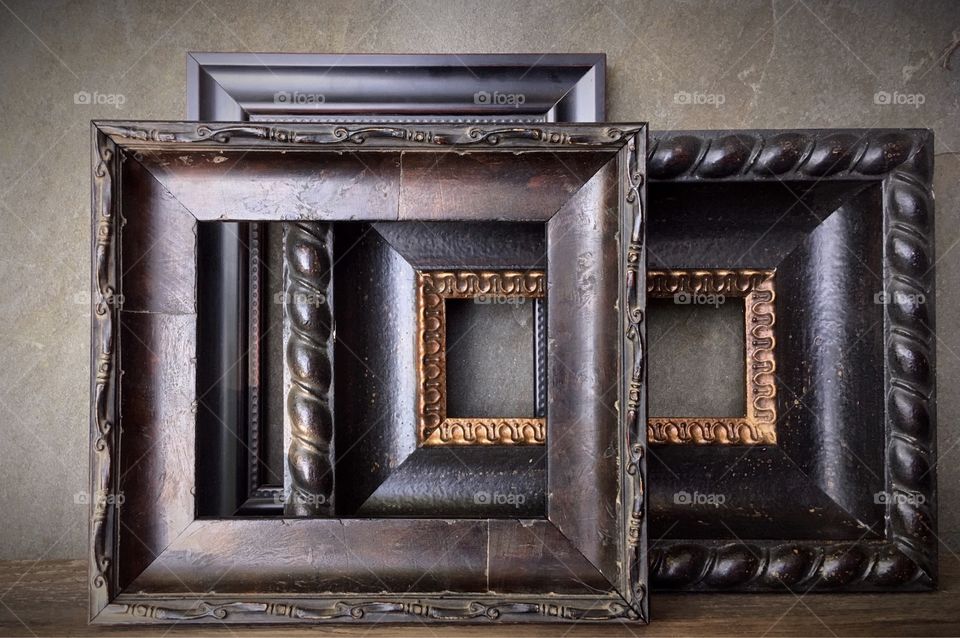 Dark Picture frames leaning against wall